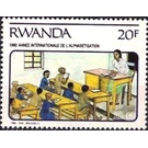 Teacher seated at desk - East Africa / Rwanda 1991 - 20